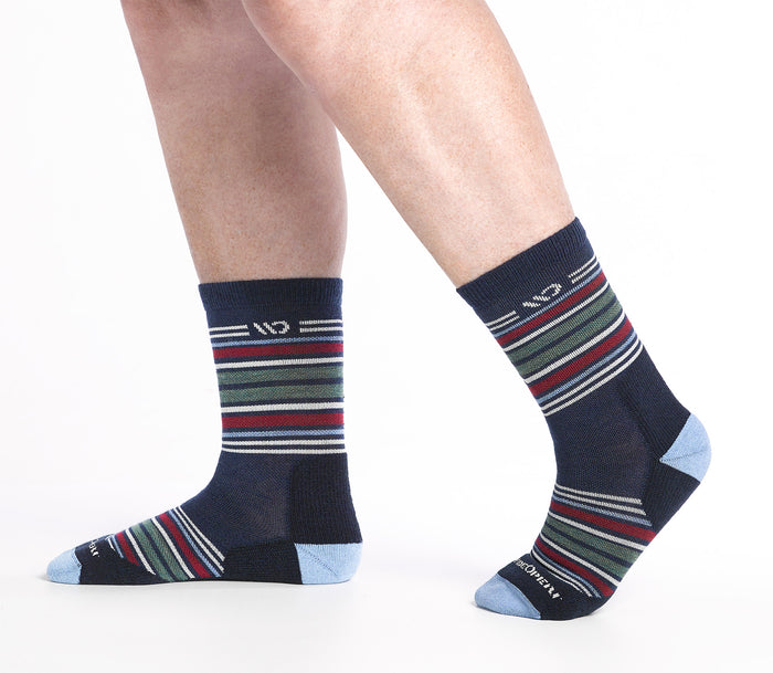 On model side shot of Micro Crew socks with blue heel/toe and Cream logo, Navy body and red and green stripes.