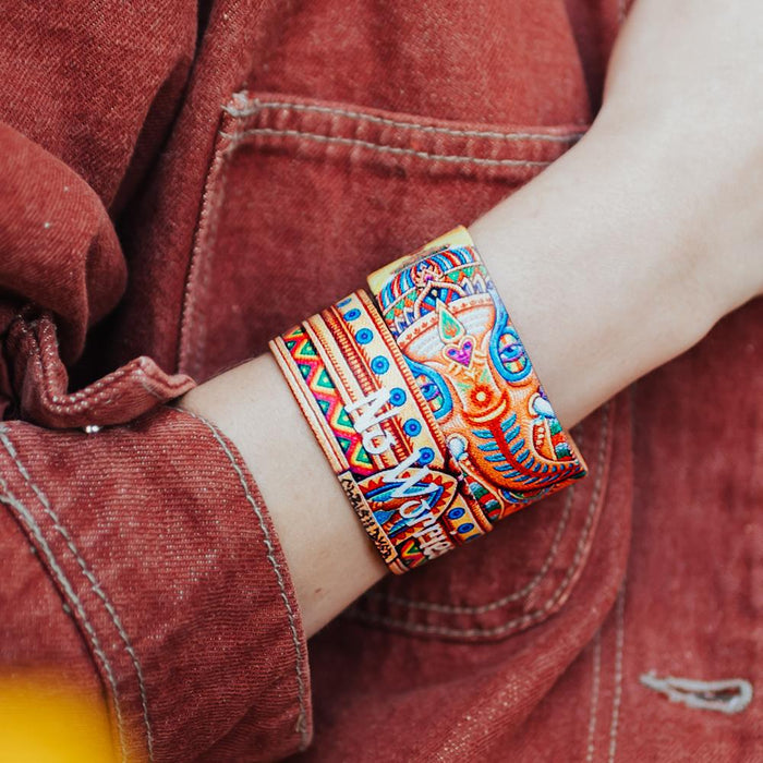 Lifestyle close up image of someone's arm wearing two No Worries straps showing the outside and inside design
