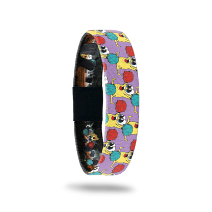 Product photo of the outside of 2021 - Day 1 - Rah Rah Ralph: purple background with repeating yellow monsters with big eyes doing a split while holding up a red and turquoise pom pom