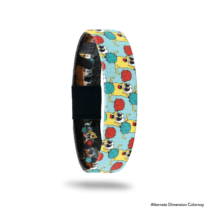 Product photo of the outside of 2021 - Day 1 - Rah Rah Ralph: light blue background with repeating yellow monsters with big eyes doing a split while holding up a red and turquoise pom pom
