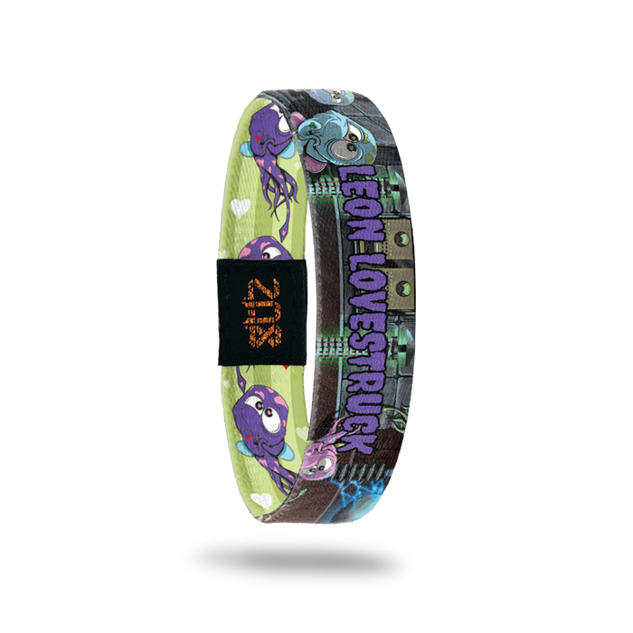 Product photo of the inside of 2021 - Day 10 - Leon Lovestruck: lab-like design with repeating purple and blue monsters with hearts all over and wings and purple 'LEON LOVESTRUCK' text