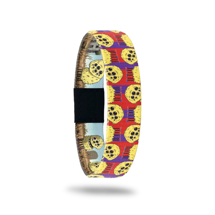 Product photo of the outside of 2021 - Day 12 - Tippi Taperoni: red and purple background with repeating yellow, furry monsters with multiple eyes and 6 legs with purple and red shoes