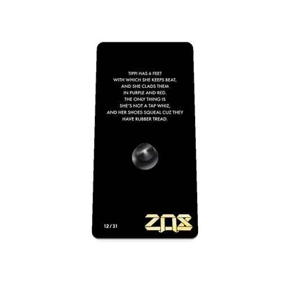 Product photo of the back of the collector’s of 2021 - Day 12 - Tippi Taperoni. It is a black background with white text ‘Tippi has 6 feet with which she keeps beat, and she clads them in purple and red. The only thing is she's not a tap whiz, and her shoes squeal cuz they have rubber tread.'