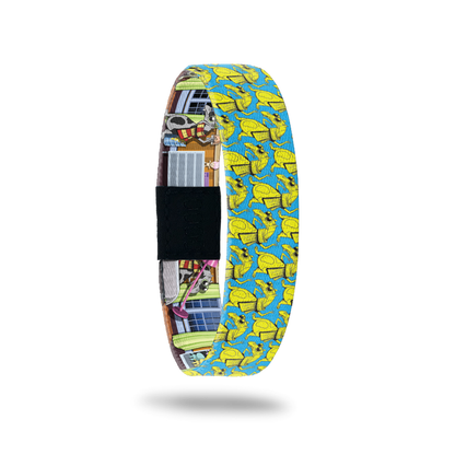 Bracelet is blue and lime green with a monster dressed as Harry Potter in a cape and scarf with glasses. Inside is the same design of the monster doing household chores. Comes with a pin of the same monster.