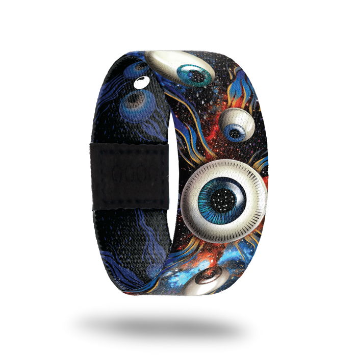 Space background with different colored eyeballs. Inside is the same in a monochromatic color and says All Eyes On Me. Comes with a matching lapel pin.