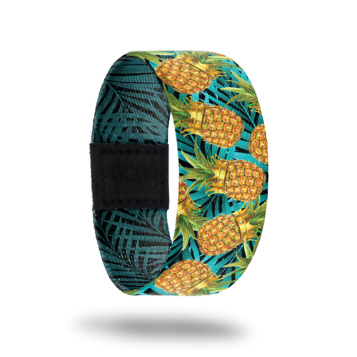 An elastic wristband that has a design on the front of pineapples wearing crowns with A bright blue background