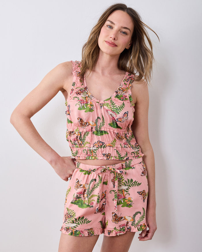 Front view of the rosewood Butterfly Forager short pajama set with a ruffle-trimmed tank and matching shorts printed with butterflies, mushrooms, and ferns.