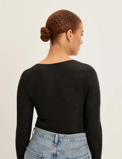 | Back view of model wearing the Cashmere Mist Scoop Top highlighting the neckline and fit | Black