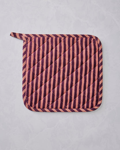 Quilted Champagne & Caviar pot holder with diagonal burgundy and peach stripes and rounded corners, shown flat.