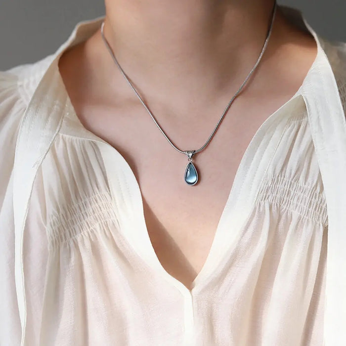 Gold-Plated Teardrop Pendant Necklace with Blue Synthetic Cat Eye Stone Crushes.