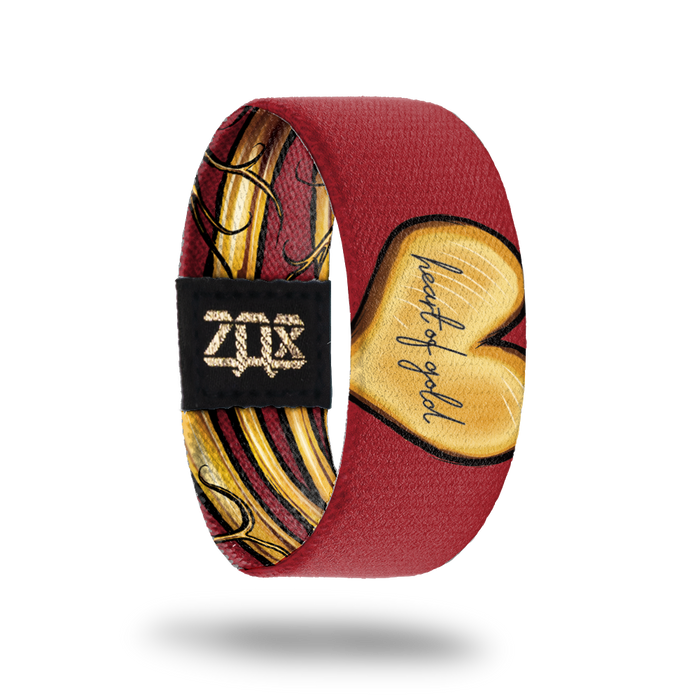 inside view of the heart of gold wristband. Dark red with gold heart shape, Heart of Gold text in the center.