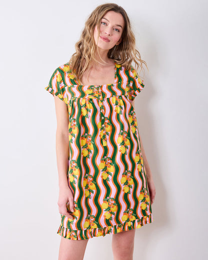 Person wearing a short-sleeve pintuck nightgown with wavy green, pink, and orange stripes and a lemon print