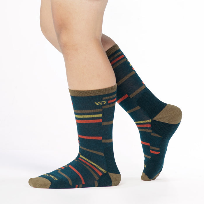 model walking to the left with back foot lifted wearing the 9010 crossroads cushioned crew in navy