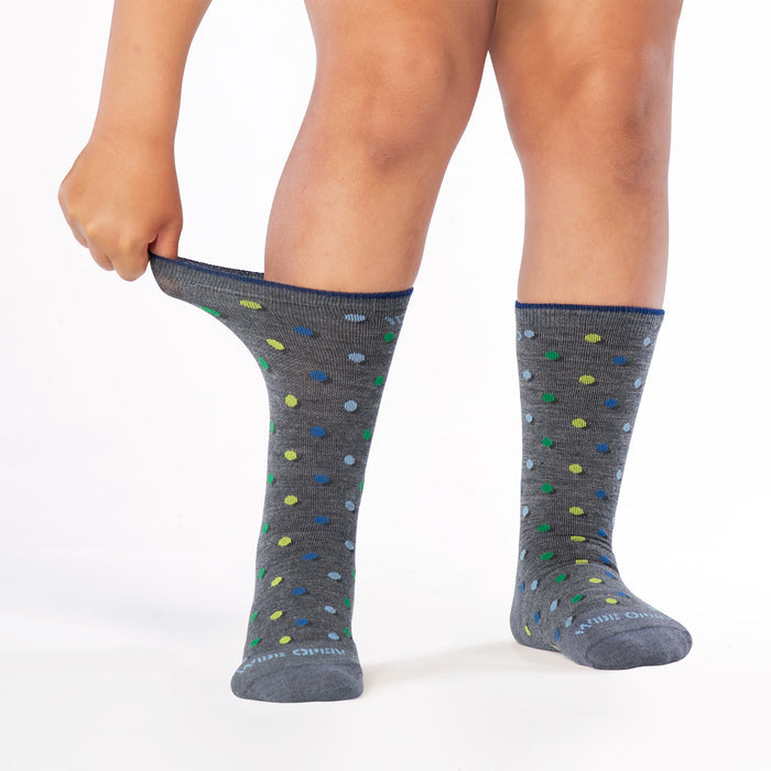 model stretching the cuff on the 9011 on the dot cushioned crew in gray