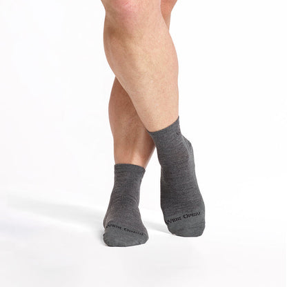models feet crossed wearing the 9014 lightweight quarter sock in gray