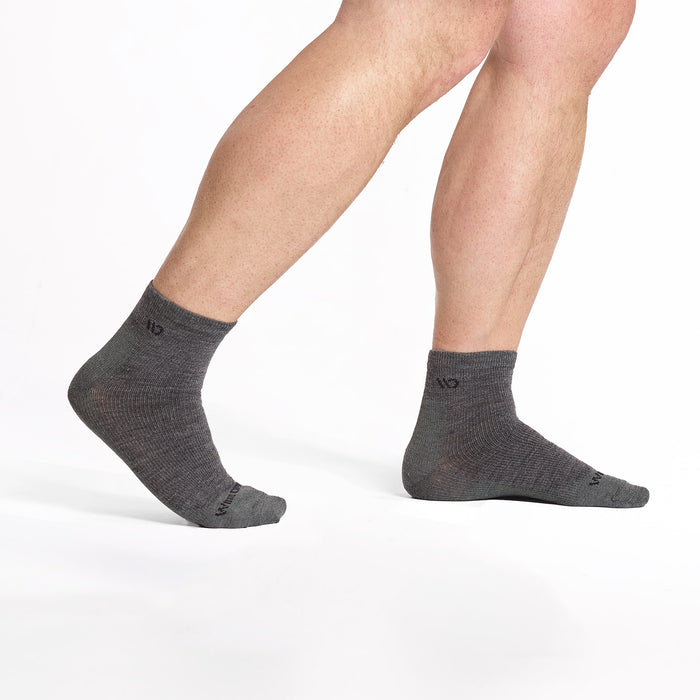 model walking to the right wearing the 9014 lightweight quarter sock in gray