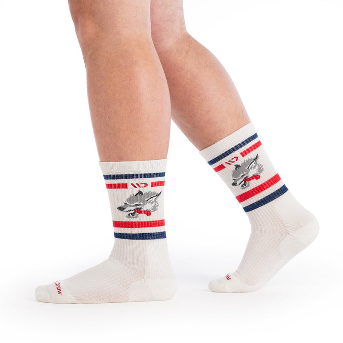 model walking to the side wearing the varsity cushioned crew in wolf white showing the wolf image on the ankle