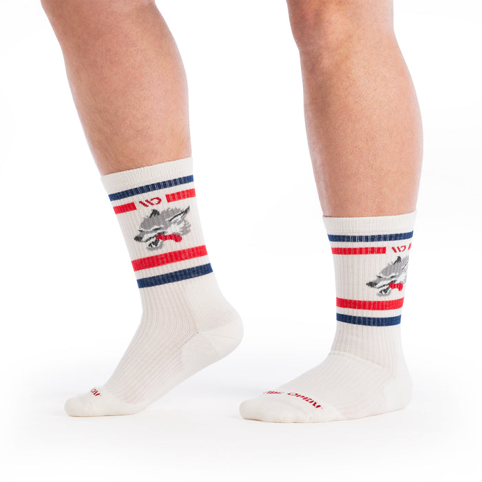 on model image with one foot raised wearing the 9007 varsity cushioned crew featuring the wolf image on the ankle