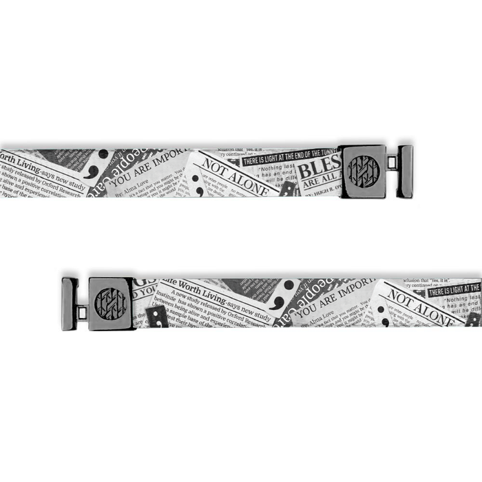 Flat hoodie string. Design is newspaper clippings in black and white. The inside reads "My Story Isn't Finished" and the aglets are black.