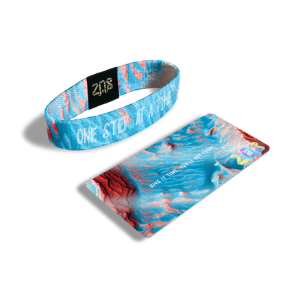 Product photo of the inside of one step at a time. It is an aerial of photoshopped image of Mars that light blue with white text one step at a time overlaying with its card saying 'Give it time, you'll get there.'
