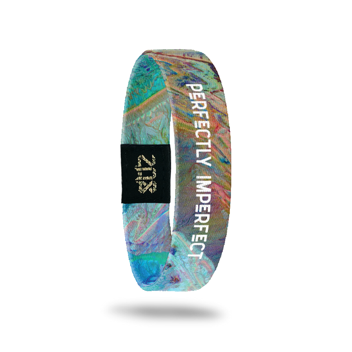 Product photo of the inside of perfectly imperfect. It is aerial of photoshopped image of earth that has a blue, purple, green, yellow and orange marble look with a white text perfectly imperfect overlaying.