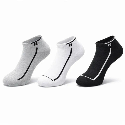 Three pairs of socks in gray, white, and black on a white background