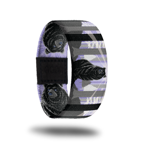Outside Design of Stand Tall: purple background with white, grey, and black tree forest and a bear in the middle