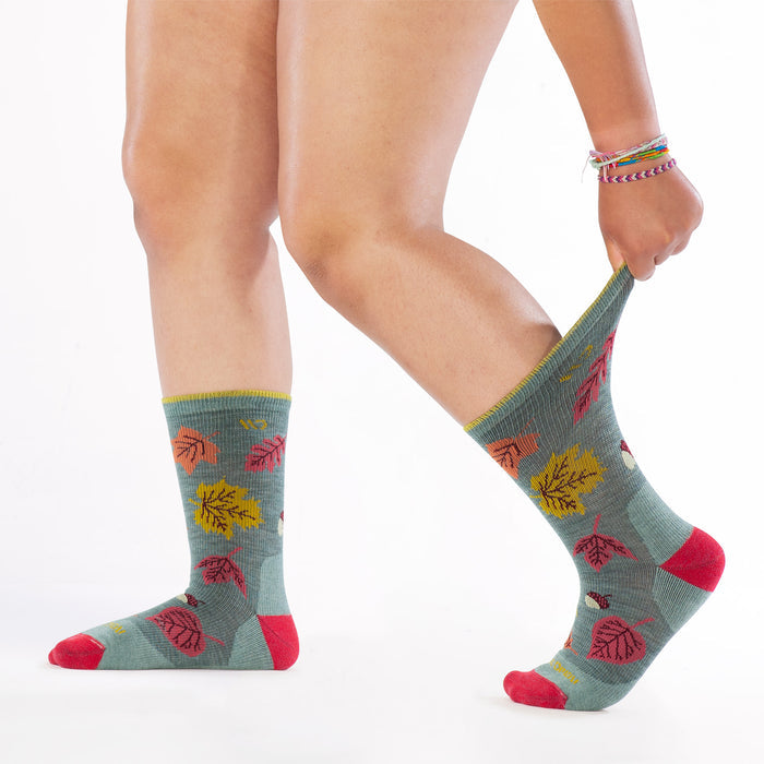 models feet to the left stretching the cuff on back foot wearing the 9511 fall in love cushioned crew in seafoam