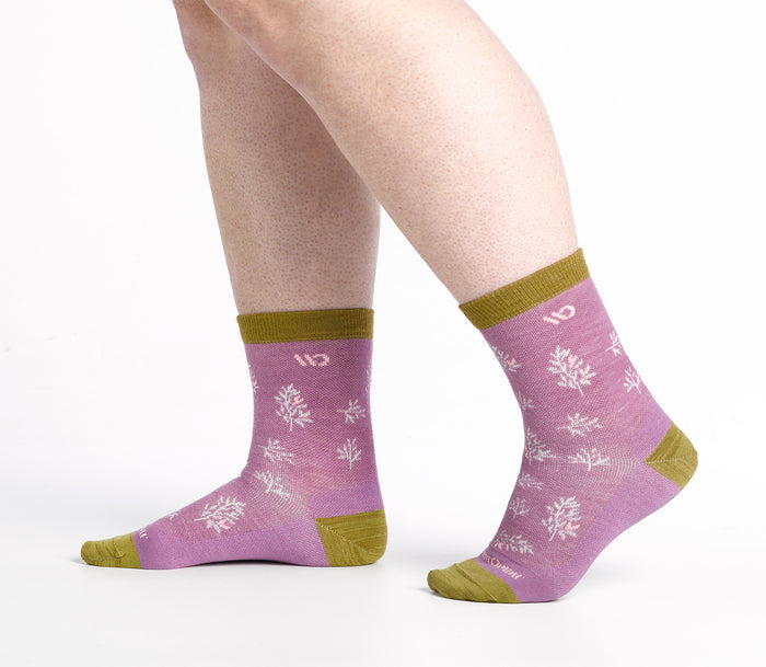 Walking side shot Micro Crews on model with gold heel/toe/cuff, Pink body and white design