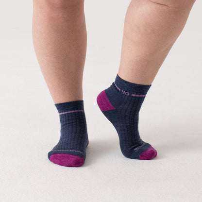 On model Quarters, fuchsia toe, lavender logo and stripe under cuff, denim body--Denim