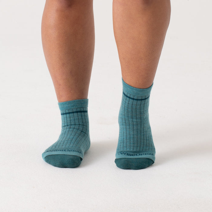 On model Quarters with dark teal heel/toe and logo, with light teal body--Light Teal