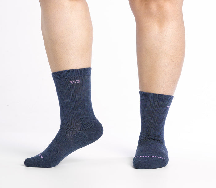 One foot to the side Solid Crews on model with denim body and Pink  logo