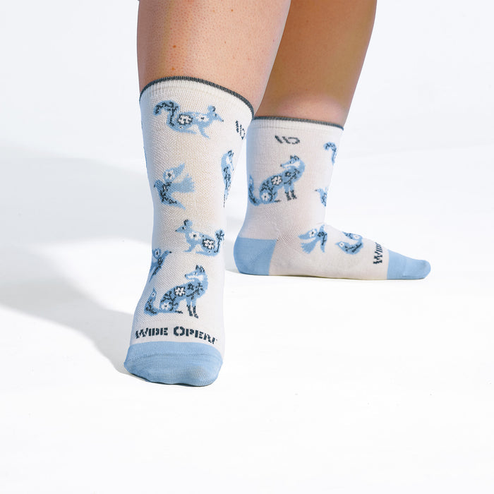 On model image of the 9516 Woodland wonder Micro Crew in White featuring the animal design on foot
